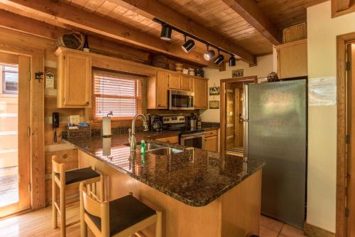 a kitchen with a granite counter top and a refrigerator at Almost Heaven in Sugar Grove
