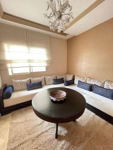 a living room with a couch and a table at Big luxury apartment near airport in Nouaceur