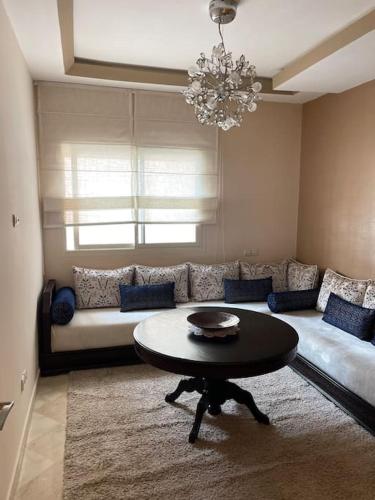 a living room with a couch and a table at Big luxury apartment near airport in Nouaceur