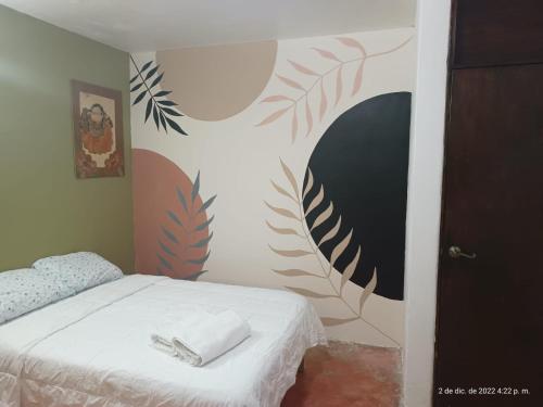 1 dormitorio con 1 cama y 2 toallas blancas en Casa de Claudia y Hugo en Oaxaca de Juárez