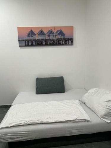 a bed in a room with a picture on the wall at Wels Inn City Apartments in Wels