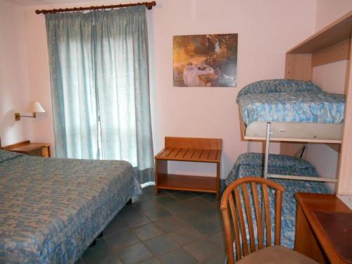 a bedroom with two bunk beds and a window at Hotel Pagnani in Pescasseroli