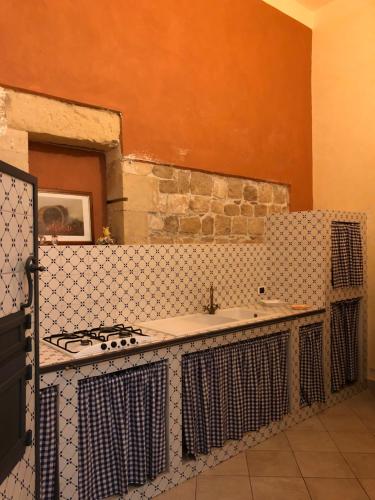 uma cozinha com um fogão e uma bancada em B&b Candido Vacanze em Modica