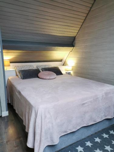 une chambre avec un grand lit blanc avec deux oreillers dans l'établissement Liladel, à Le Mont-Dore