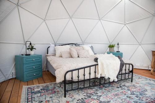 a bedroom with a bed in a yurt at Little Village Retreat in New Harmony