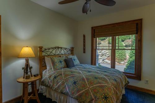 a bedroom with a bed and a window at Heart Rock Lodge in Sugar Mountain