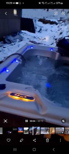 a bath tub with snow on the sides of it at Aurora Dream in Svensby