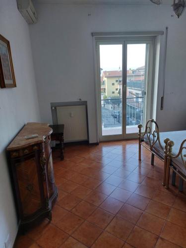 a room with a tiled floor with a large window at Casa Roncaccia in Grottaferrata