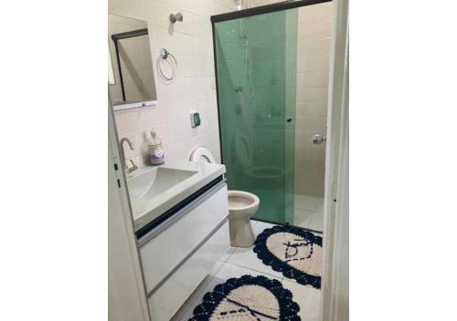 a bathroom with a shower and a sink and a toilet at WR7 Hostel in São Bernardo do Campo