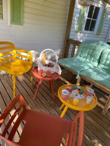 a patio with chairs and tables and a table with a toy at Mobilhome à la campagne in Porto-Vecchio
