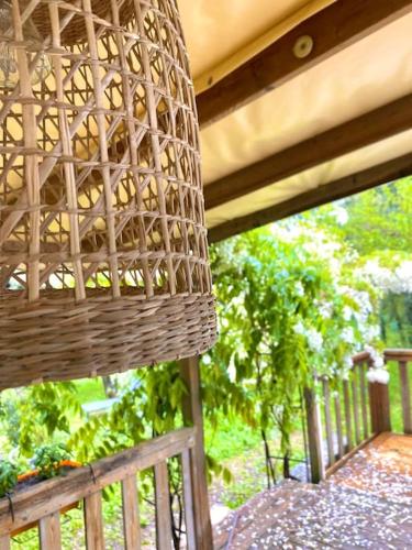 a wicker basket sitting on top of a porch at Mobilhome à la campagne in Porto-Vecchio