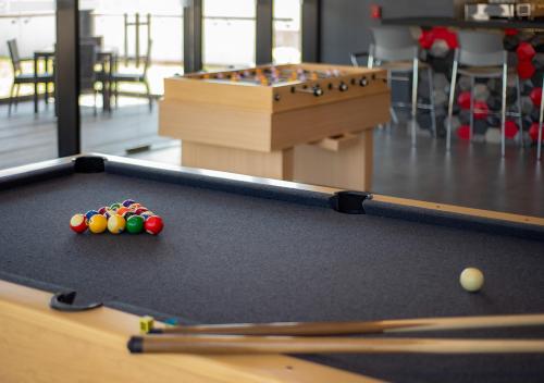 a pool table with balls on top of it at Ramada Encore by Wyndham Guadalajara Aeropuerto in Guadalajara