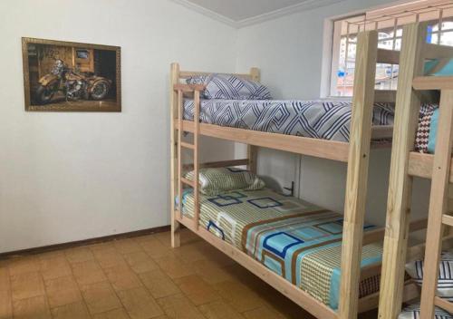 a bedroom with two bunk beds with a motorcycle on the wall at WR7 Hostel in São Bernardo do Campo