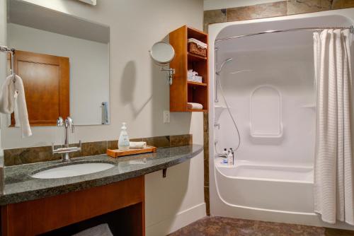 a bathroom with a sink and a shower at Misty Mountain- Premium 2 Bedroom Mountain View in Canmore