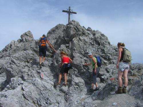 a group of people on a mountain with a cross on top at Haus Christopherus in Klösterle am Arlberg