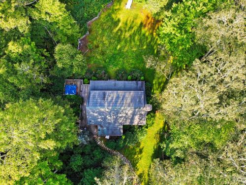 an overhead view of a house in the forest at Winds Aloft in Newland