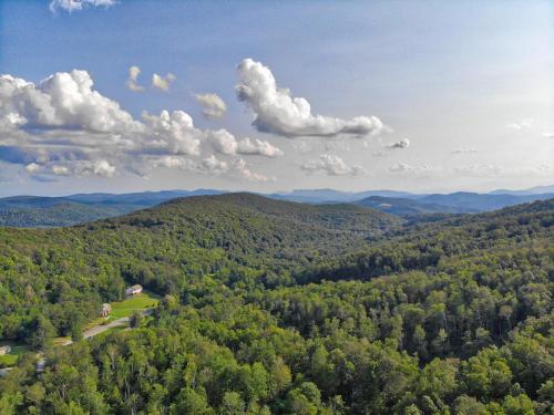 an aerial view of a forested area with a house at Winds Aloft in Newland
