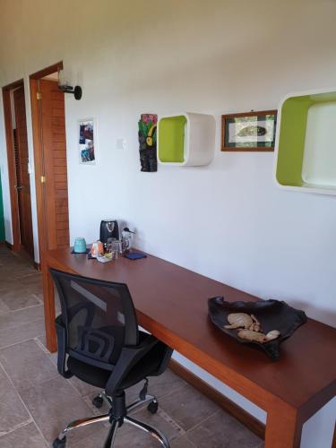 a desk in a room with a chair and a computer at Palmetto Lodge in Playa San Miguel 