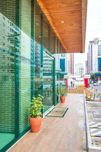 a building with potted plants on the side of it at Sotero Hotel by Castelo Itaipava in Salvador