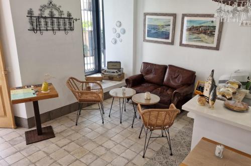 a living room with a couch and a table and chairs at OPUNTIA Hotel Boutique in Mijas