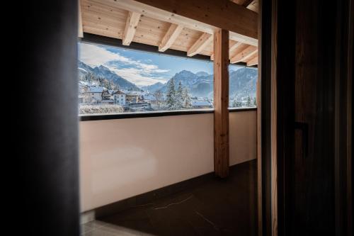 a window in a room with a view of a mountain at CHALET NORA in San Vigilio Di Marebbe