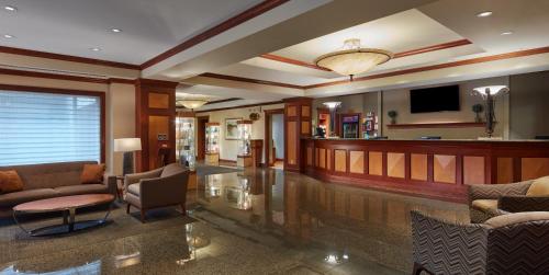 a lobby with couches and a bar in a hotel at Harrah's Joliet, A Caesars Destination in Joliet