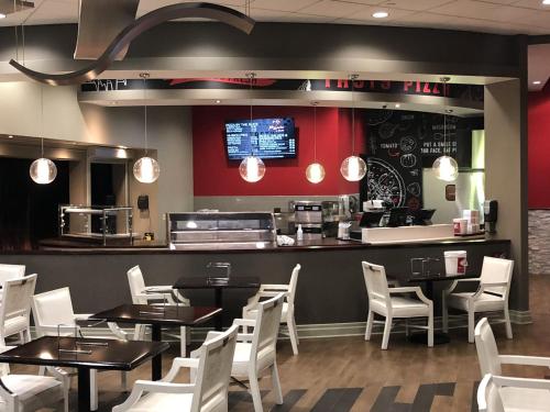 a restaurant with tables and chairs and a counter at Harrah's Joliet, A Caesars Destination in Joliet