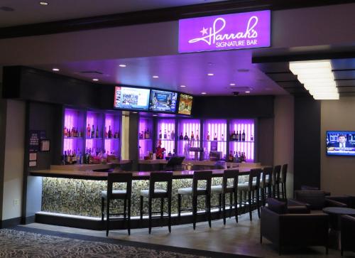 a bar in a restaurant with purple lighting at Harrah's Joliet, A Caesars Destination in Joliet