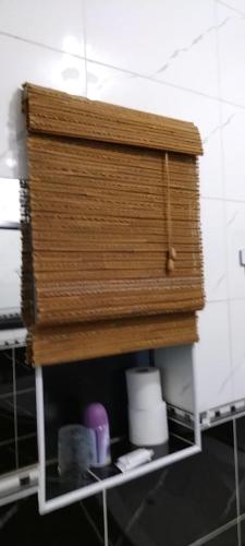 a wooden shelf in the corner of a bathroom at Cheers in Evander