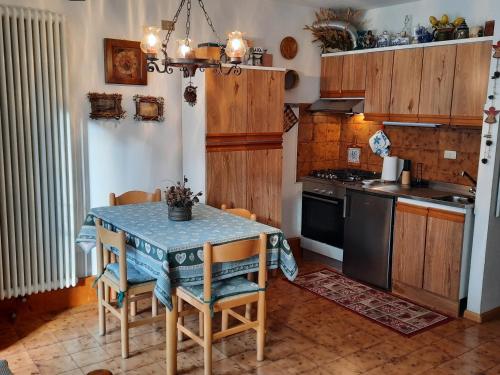 a kitchen with a table and a stove at Casa Fiore in Dimaro