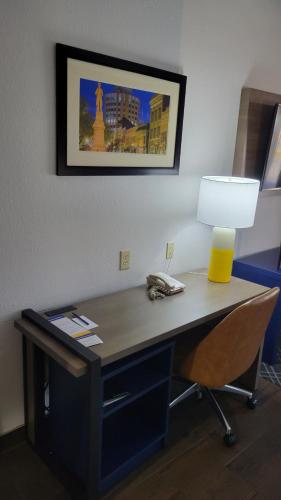 a desk in an office with a lamp and a phone at Comfort Suites Macon Northwest in Macon