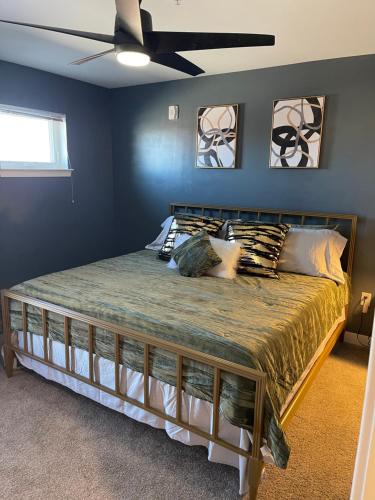 a bedroom with a large bed with a ceiling fan at Scott’s Addition in Richmond