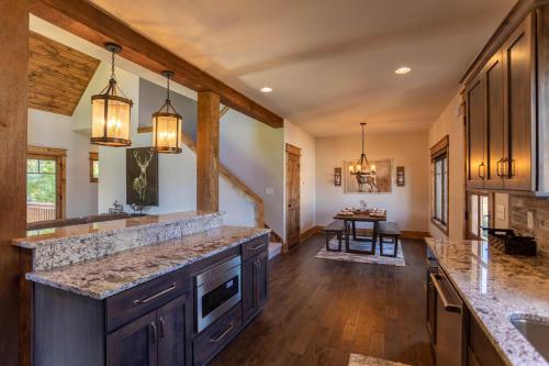 a large kitchen with wooden floors and wooden beams at The Sheltered Elk at Eagles Nest in Elk Park