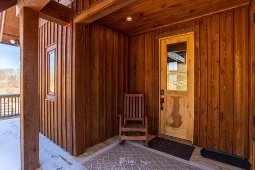 a wooden room with a wooden chair and a door at Mio Nido at Eagles Nest in Newland