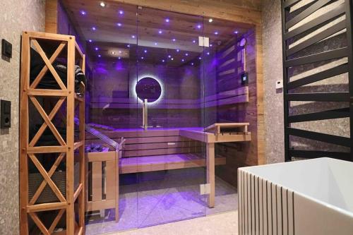 a purple room with a bench and a table at Kitzbüheler Alpenpenthouse *private Sauna&Whirlpool* by STELLENBERG living in Hollersbach im Pinzgau
