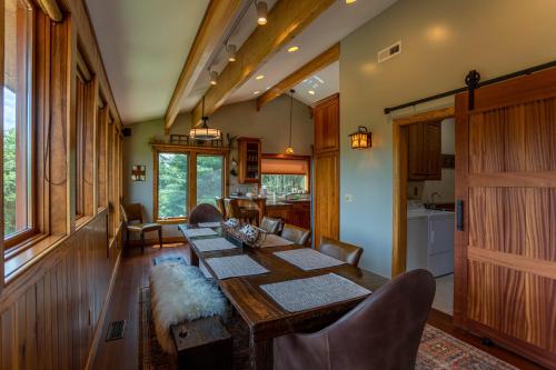 a dining room with a long table and chairs at Mountaineer Manor in Sugar Grove