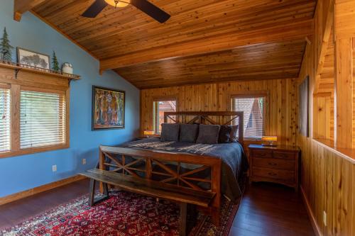 a bedroom with a bed and a wooden ceiling at Mountaineer Manor in Sugar Grove