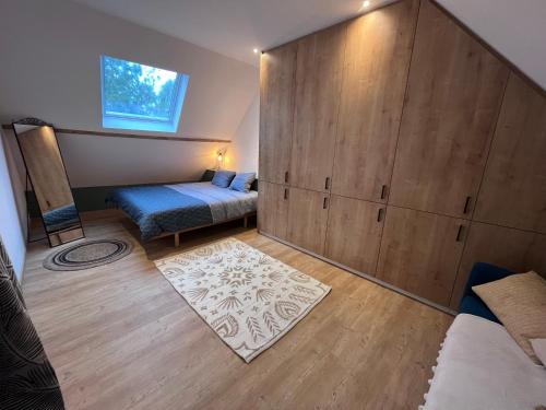 a bedroom with a bed and a large wooden wall at Ferme du Grand Fresnoy in Molenbaix