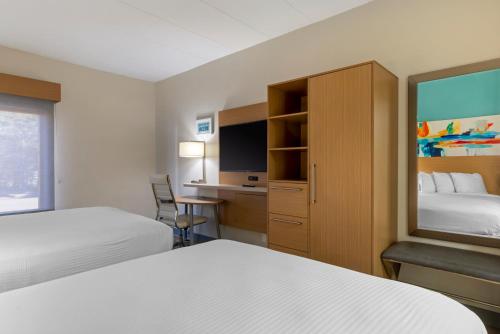 a hotel room with two beds and a desk at Best Western PLUS Executive Hotel Richmond in Richmond