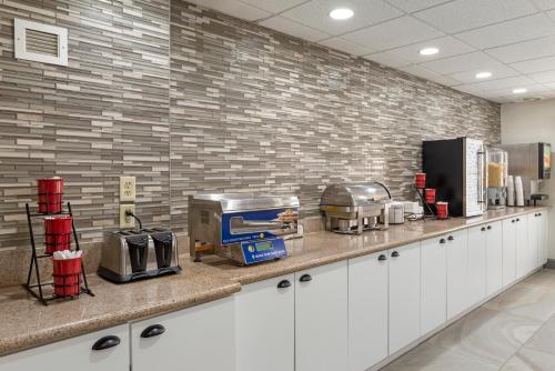 a kitchen with a counter with appliances on it at Best Western PLUS Executive Hotel Richmond in Richmond
