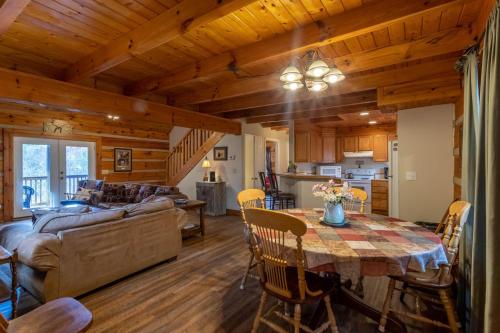 a dining room and living room with a table and a couch at River Ridge in Boone