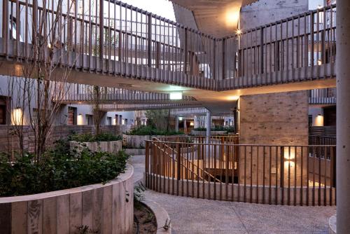 a large building with a staircase in a courtyard at Casagrande Hotel & Beach Club in José Ignacio