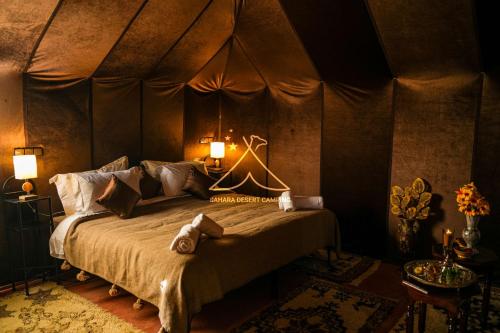 A bed or beds in a room at Sahara Desert Camping Merzouga & Erg Chebbi Dunes