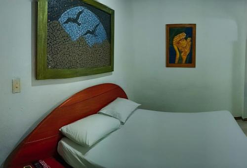 a white bed in a room with a red couch at Playa Mar Sun Caribe in Turbo