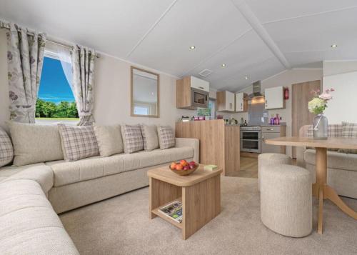 a living room with a couch and a table at Ladys Mile Holiday Park in Dawlish