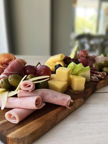 a plate of food with meat cheese and other foods at Casagrande Hotel & Beach Club in José Ignacio