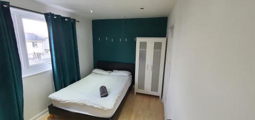 a small room with a bed and a window at Glenfield Park House in Leicester