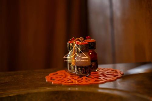 a bottle of sauce sitting on top of a table at Sahara Desert Camping - Luxury Desert Camp Merzouga in Erfoud