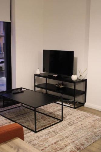 a living room with a tv and a coffee table at Amazing Luxury One Bedroom Apartment in the heart of Preston in Preston