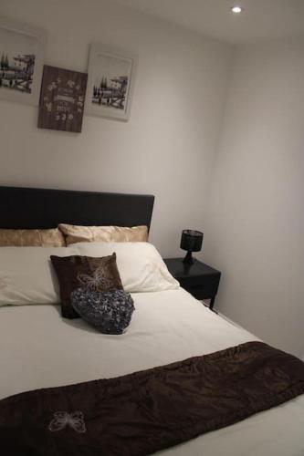 a bed with two pillows on it in a bedroom at Amazing Luxury One Bedroom Apartment in the heart of Preston in Preston